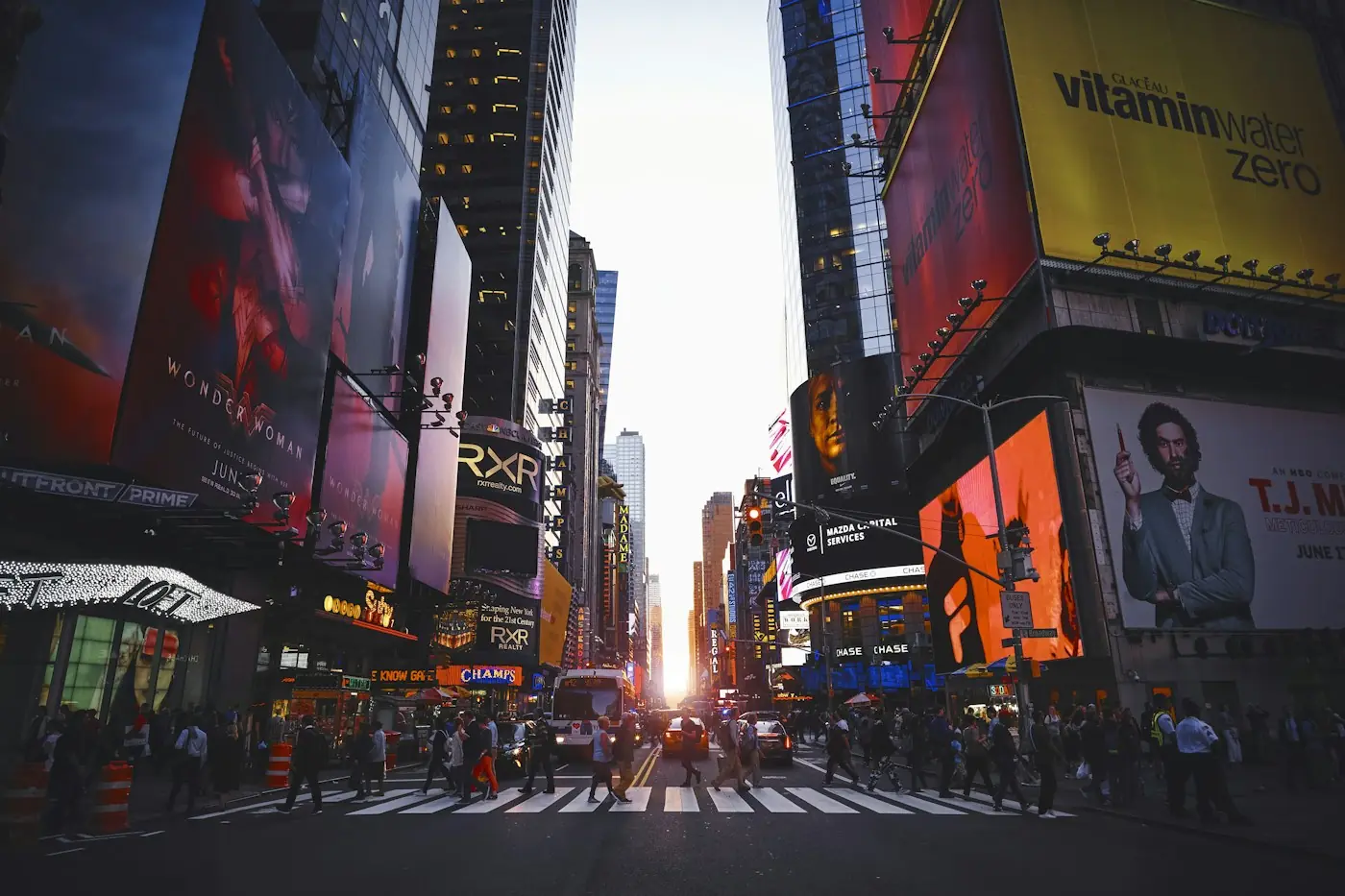 Bright billboards lighting up a busy city crossing